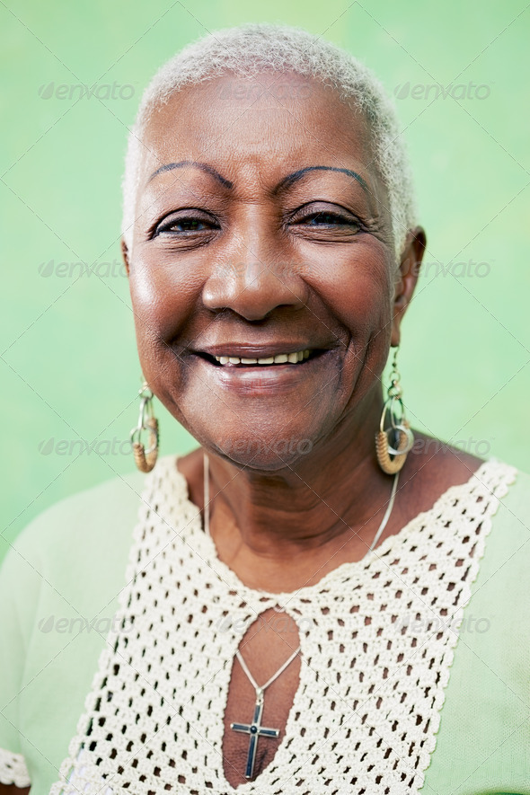 Portrait of senior black woman smiling at camera on green background-02